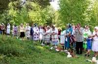 Worshippers standing opposite a spruce where men were conducting prayers in a sacred grove near the village of Marisola in the Marii El republic.